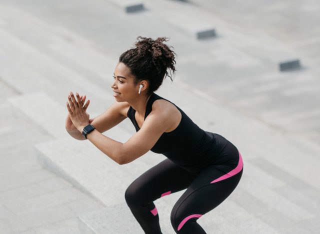 woman doing jump squats, concept of exercises to melt love handles