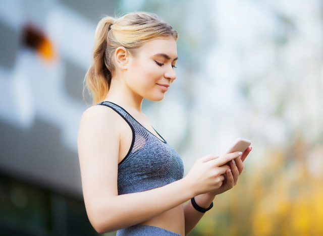 athletic woman looking at phone