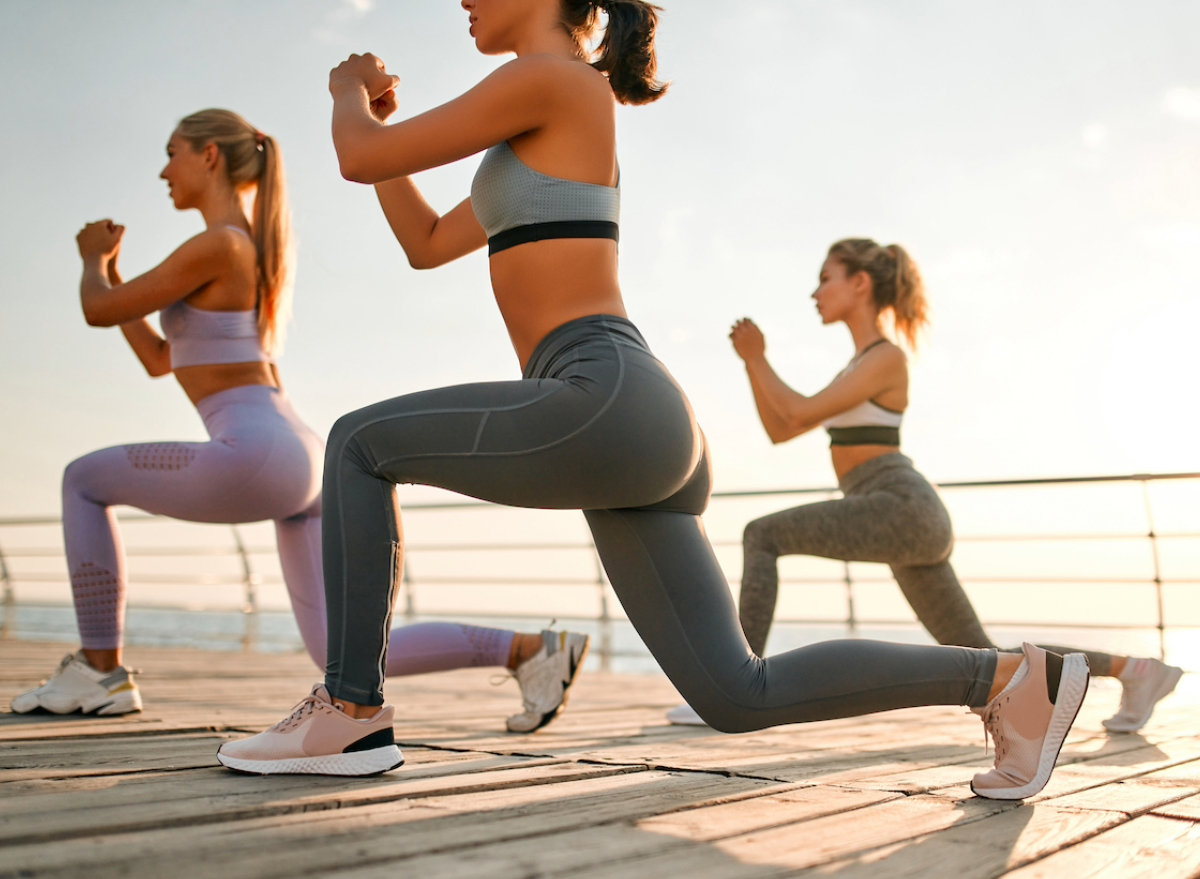 group of women doing lunges, concept of 30-day standing workout to slim down lower half