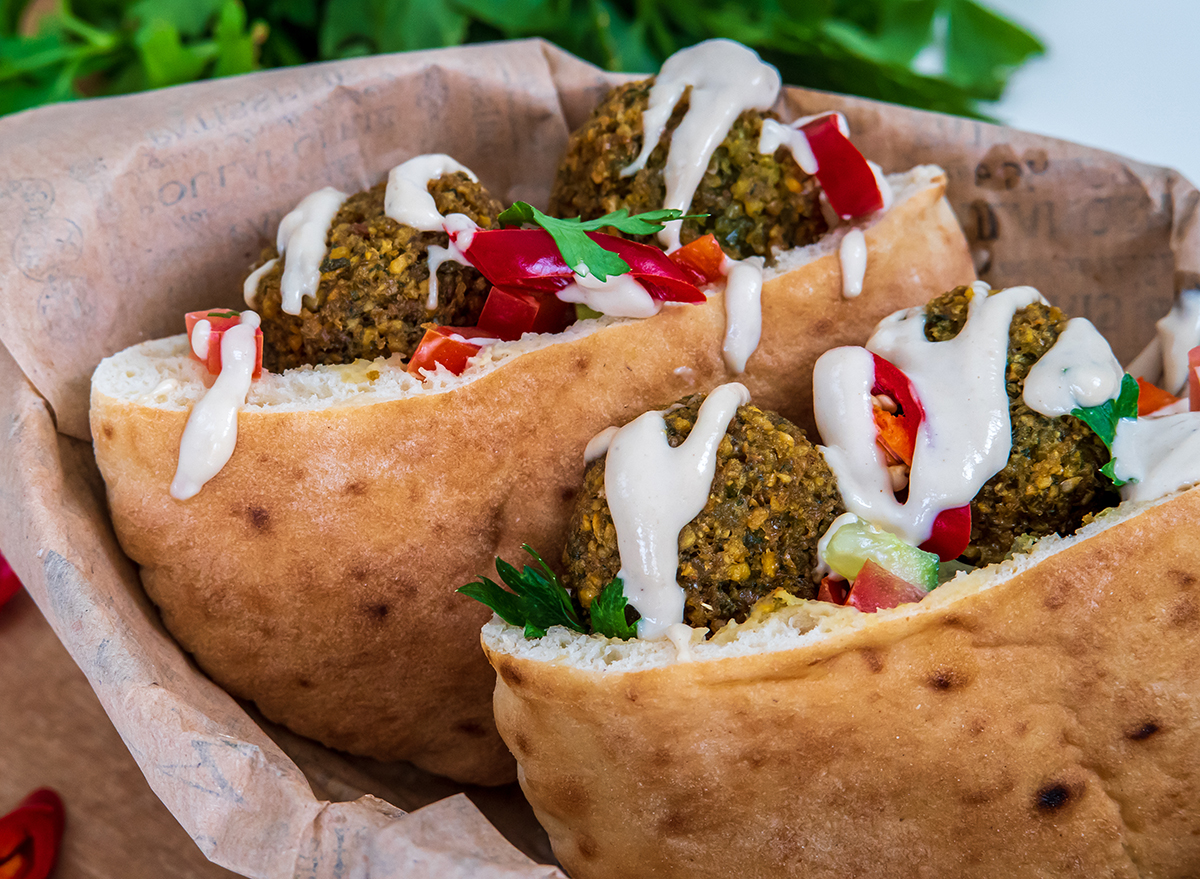 Authentic fresh falafel balls inside of two halves of pita bread sandwich