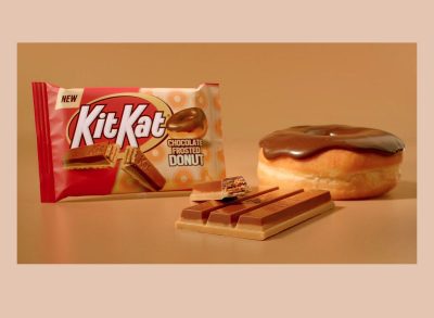 kit kat chocolate frosted donut package displayed beside a real donut and the candy