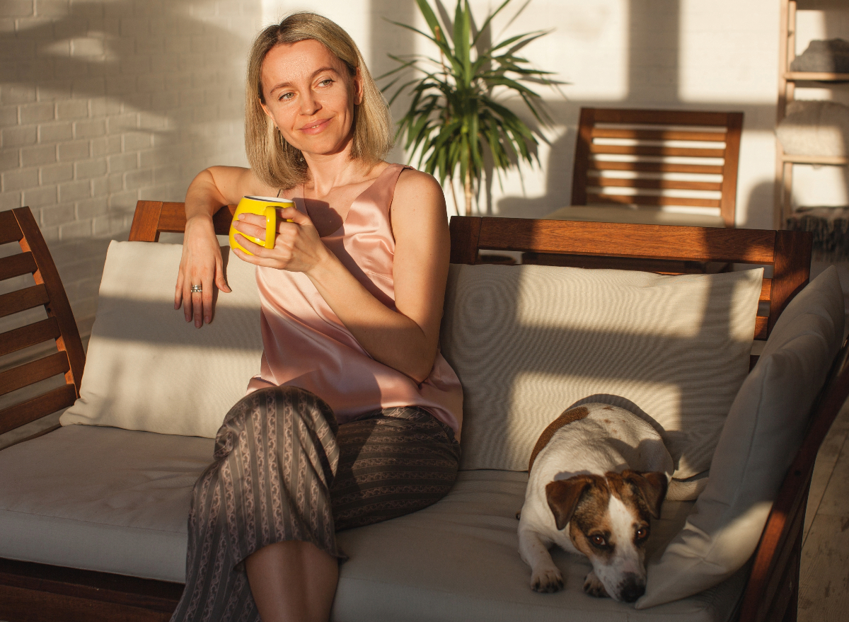 happy woman enjoying morning coffee, concept of morning habits from longest-living people
