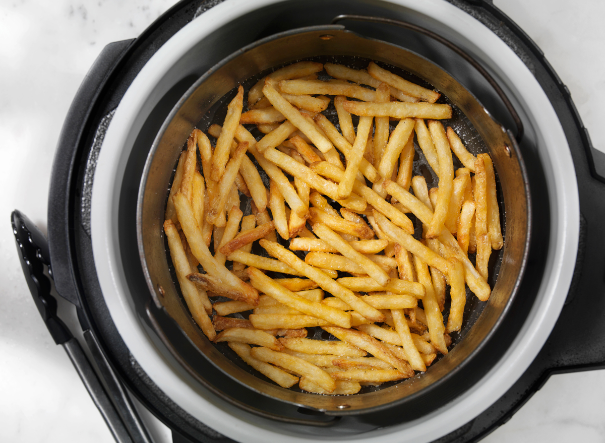 frozen french fries being cooked in an air fryer