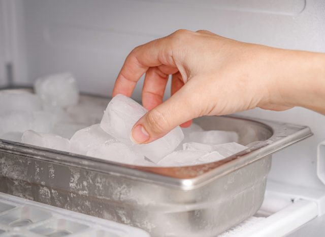 reaching for ice cube in freezer