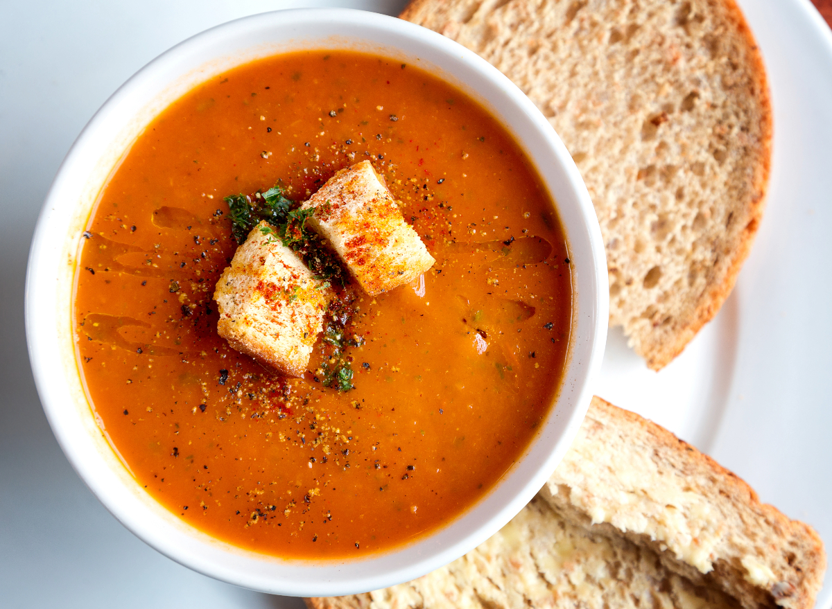 tomato soup with seasonings, croutons, and bread