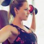 woman doing dumbbell press, concept of morning workouts to speed up weight loss