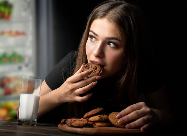 woman eating cookies at night