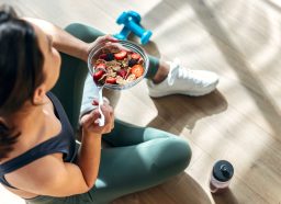 woman eating hearty breakfast before workout, concept of ways to burn an extra 100 calories a day
