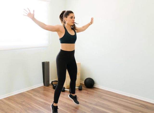 woman doing jumping jacks, concept of exercises to stay fit when short on time