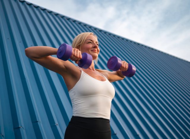 woman lifting weights, concept of 75 Hard Challenge workout