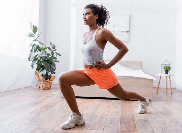 woman lunges in bedroom, concept of at-home workouts for belly fat