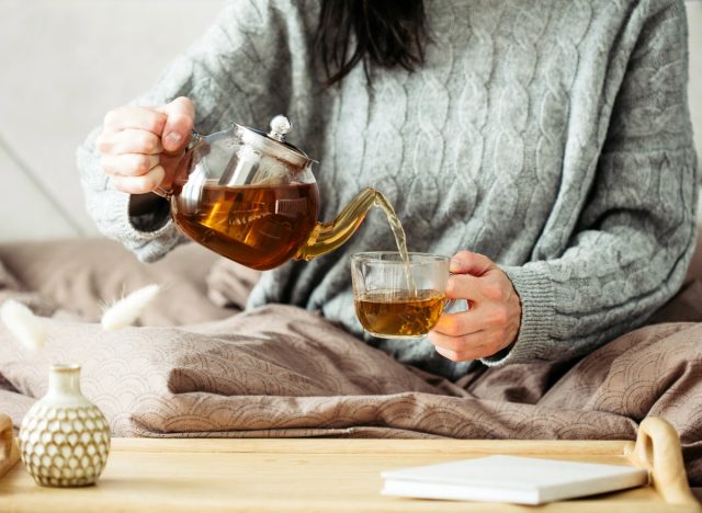 woman pouring tea, concept of ways to speed up metabolism