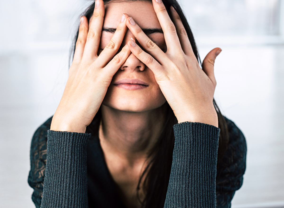 woman covering her eyes feeling stressed, concept of ways to relieve stress in less than five minutes