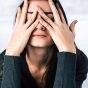 woman covering her eyes feeling stressed, concept of ways to relieve stress in less than five minutes