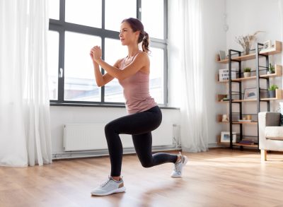 woman doing walking lunges, concept of quick and easy workouts for the holidays to stay on track