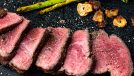 Chateaubriand filet with onion and asparagus, on plate