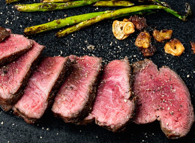 Chateaubriand filet with onion and asparagus, on plate