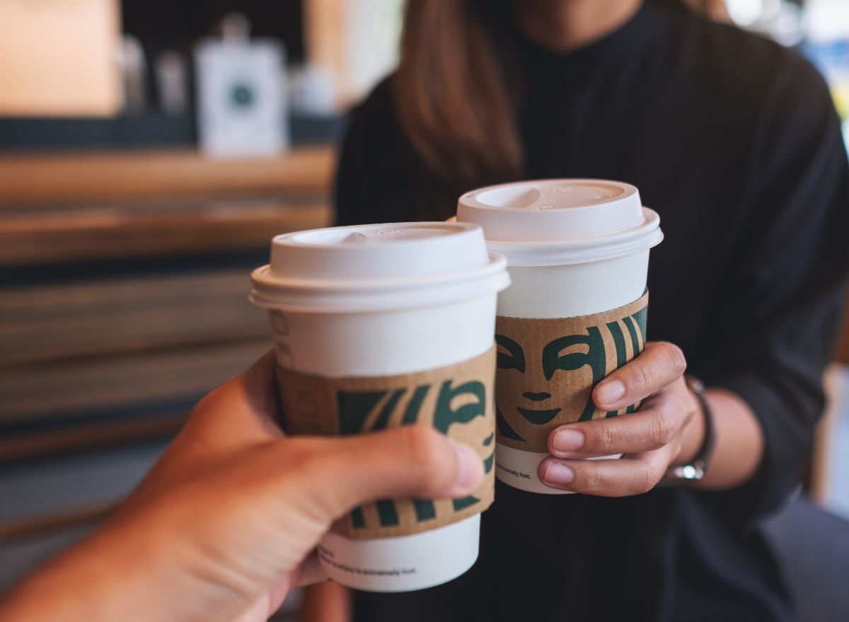 Starbucks customers holding cups