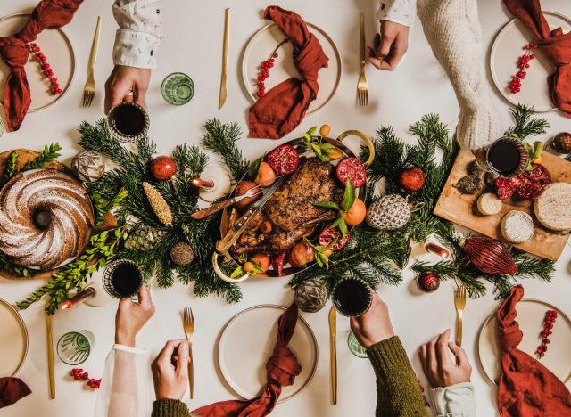 Christmas dinner table, people toasting, concept of mindful holiday eating tips