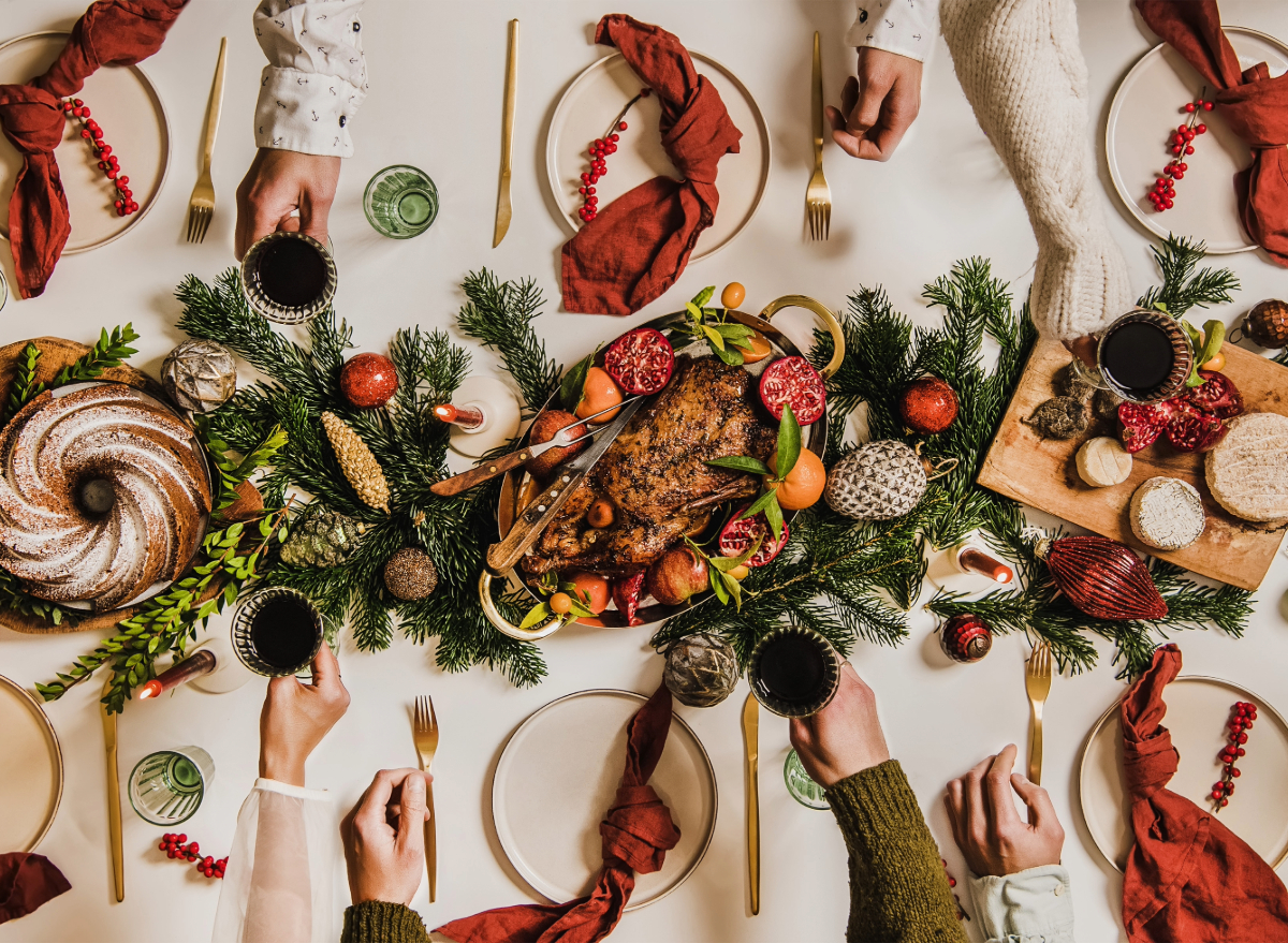 Christmas dinner table, people toasting, concept of mindful holiday eating tips