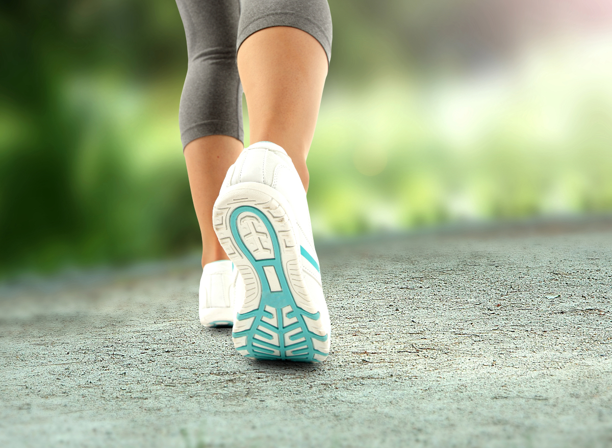 close-up of sneakers, woman walking, concept of how many daily steps to lose weight