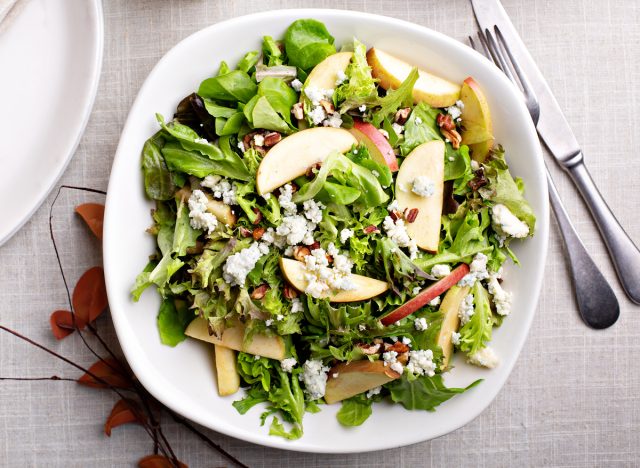 fall salad with lettuce, apples, dried fruit, and walnuts