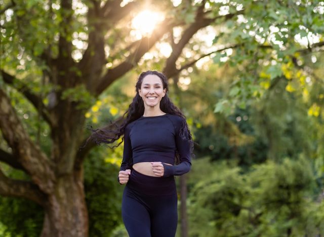 happy woman running outdoors