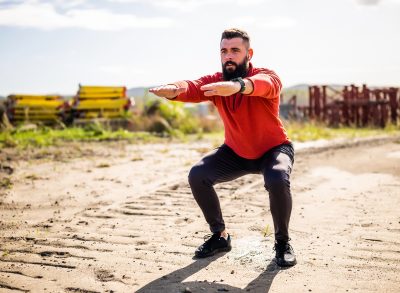 man doing squats, concept of exercises for men to build muscle