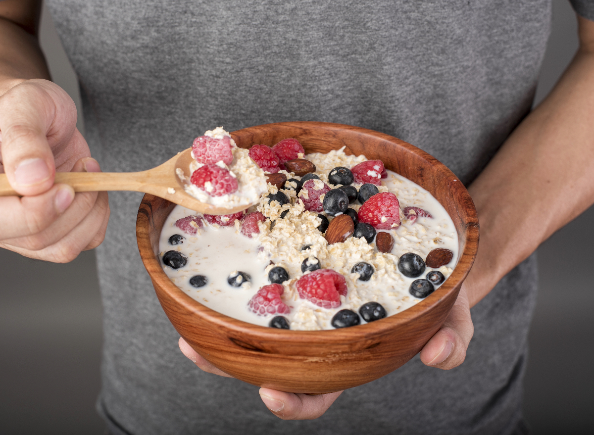 man holding hearty bowl of oats, concept of diet habits to live longer