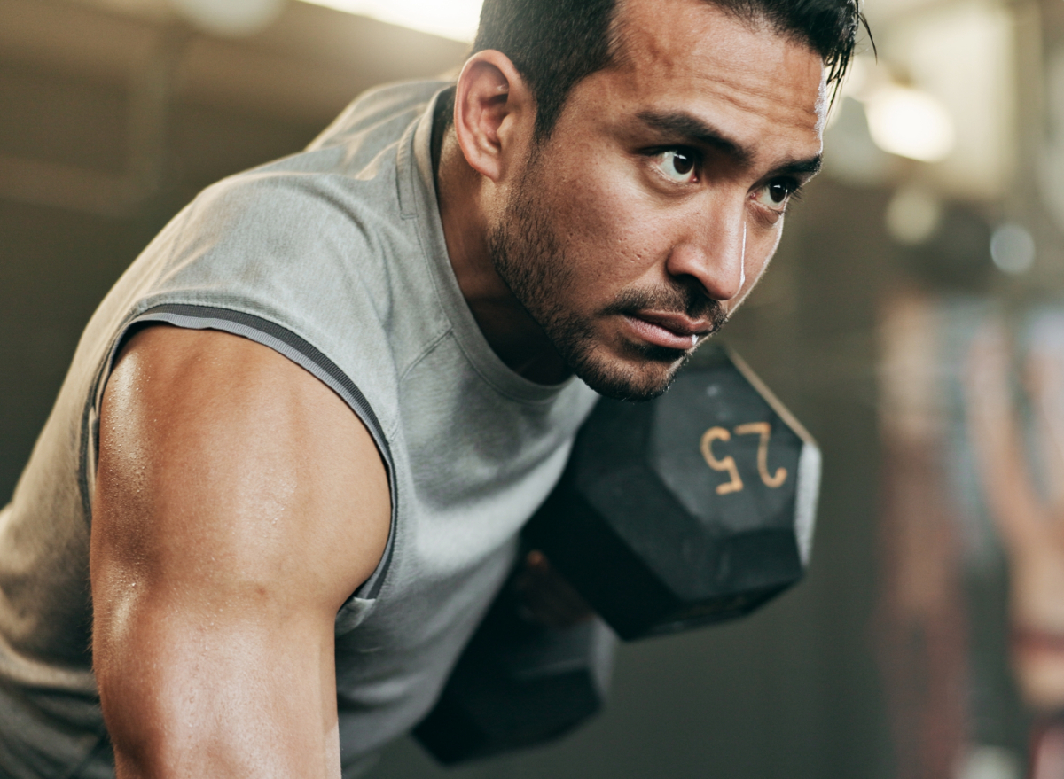 man lifting weights, concept of fitness rules to abandon for the best results