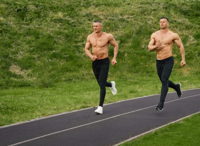 two muscular men running