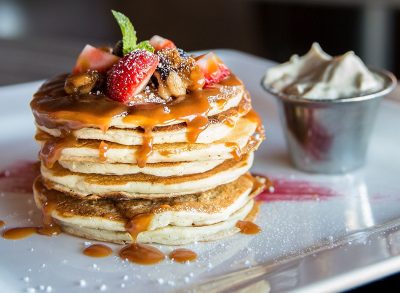 Pancakes loaded with caramel strawberries and chocolate