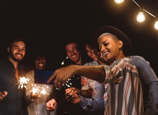 friends taking selfie with sparklers for new year's eve