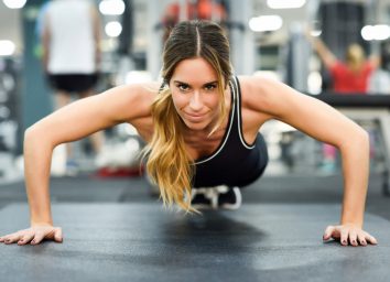 woman doing pushups, concept of strength exercises to tone your body