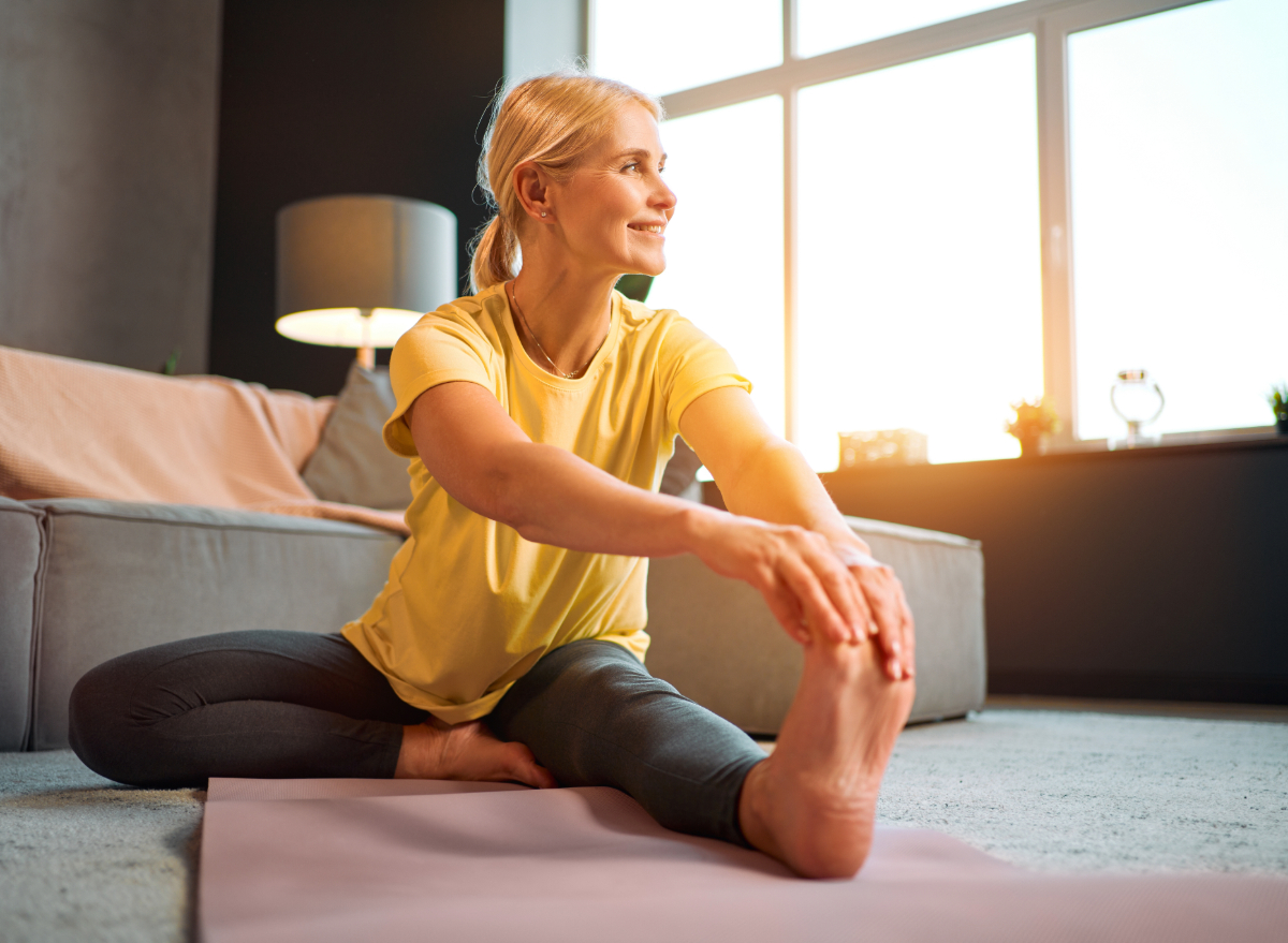 woman stretching indoors, concept of weight loss habits