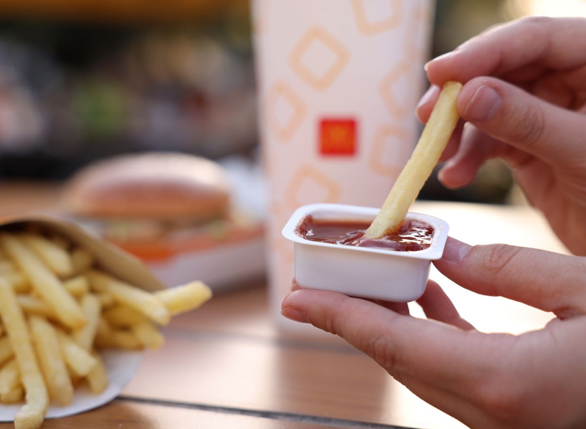 McDonald's customer dipping fry in sauce