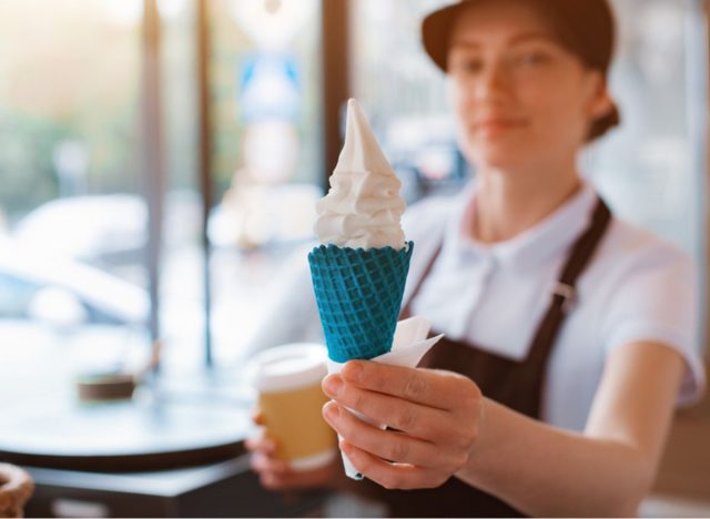 woman serving a cone of ice cream