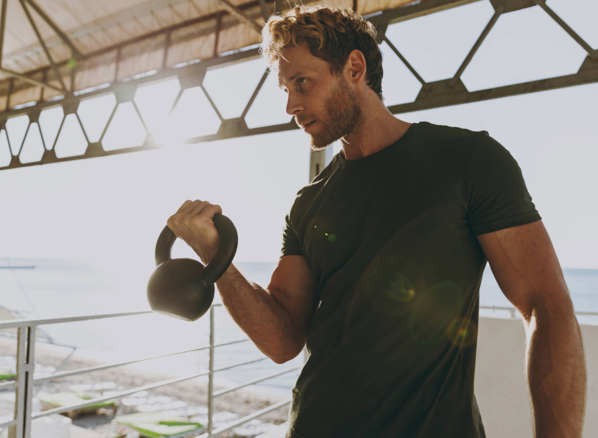 fit man holding kettlebell, concept of strength workouts to boost your muscular endurance