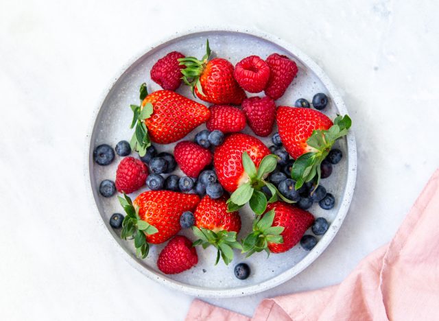 bowl of fresh berries that includes strawberries raspberries and blueberries