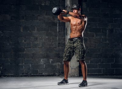 man doing kettlebell swing, concept of workout to increase stamina