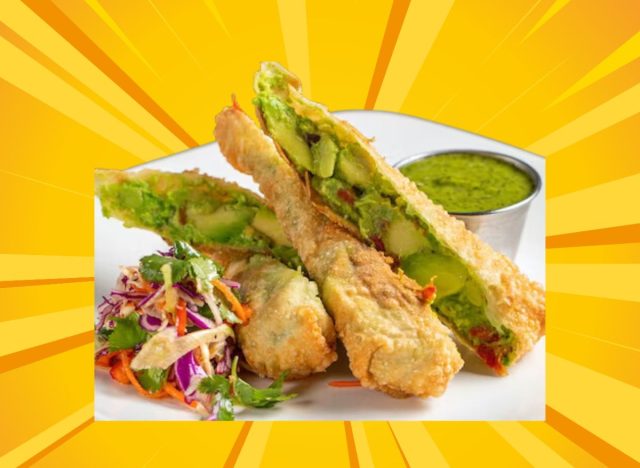 kona grill avocado egg rolls arranged on a plate with dipping sauce, against a bright yellow designed background