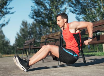 man doing tricep dips, concept of exercises to improve muscular endurance