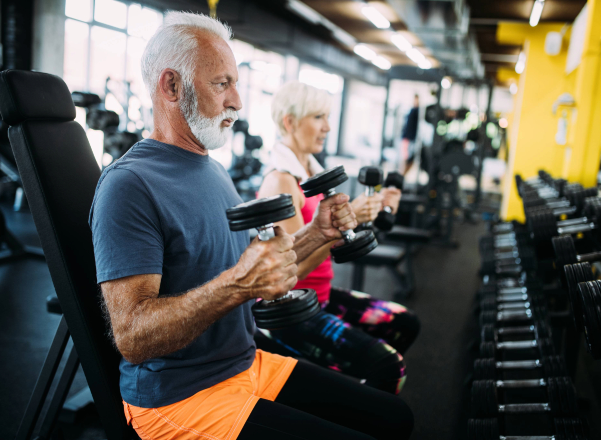 mature man lifting weights, concept of strength exercises to regain muscle mass