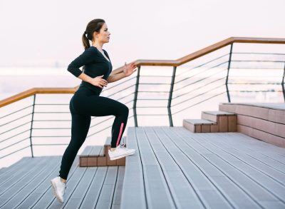 woman doing stair runs, concept of cardio exercises for faster weight loss