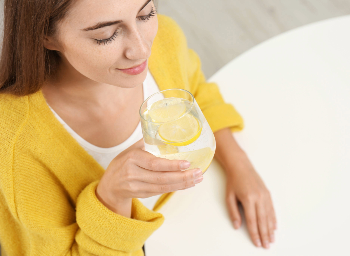 woman drinking lemon water for weight loss concept