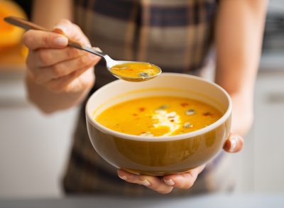 woman holding a bowl of soup