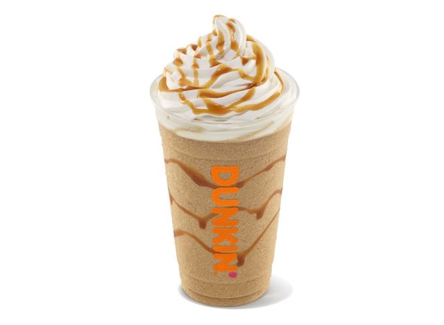 Dunkin' frozen coffee drink with whipped cream and caramel drizzle
