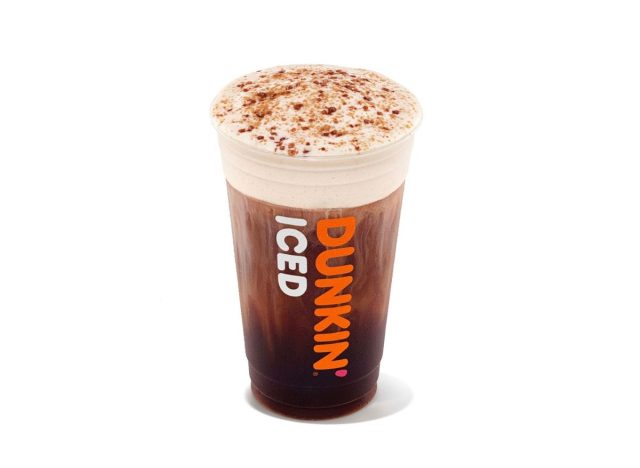 cup of Dunkin' cold brew with cold foam and crunchy toppings on a white background