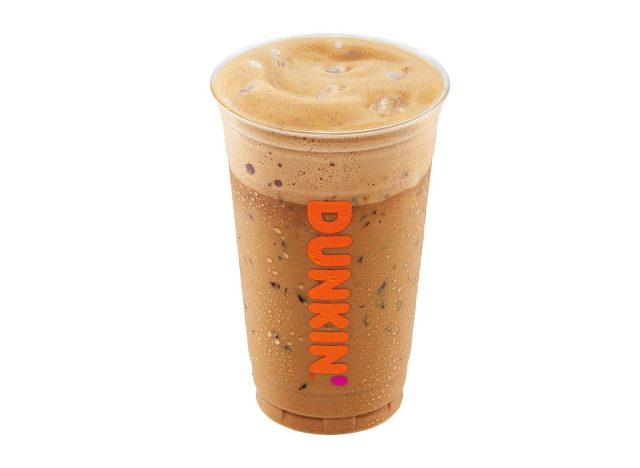 Cup of Dunkin' iced french vanilla cappuccino on white background