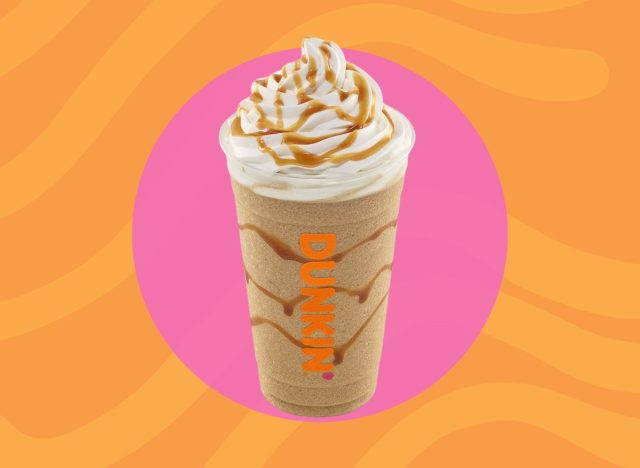 cup of Dunkin' frozen drink with whipped cream and drizzle